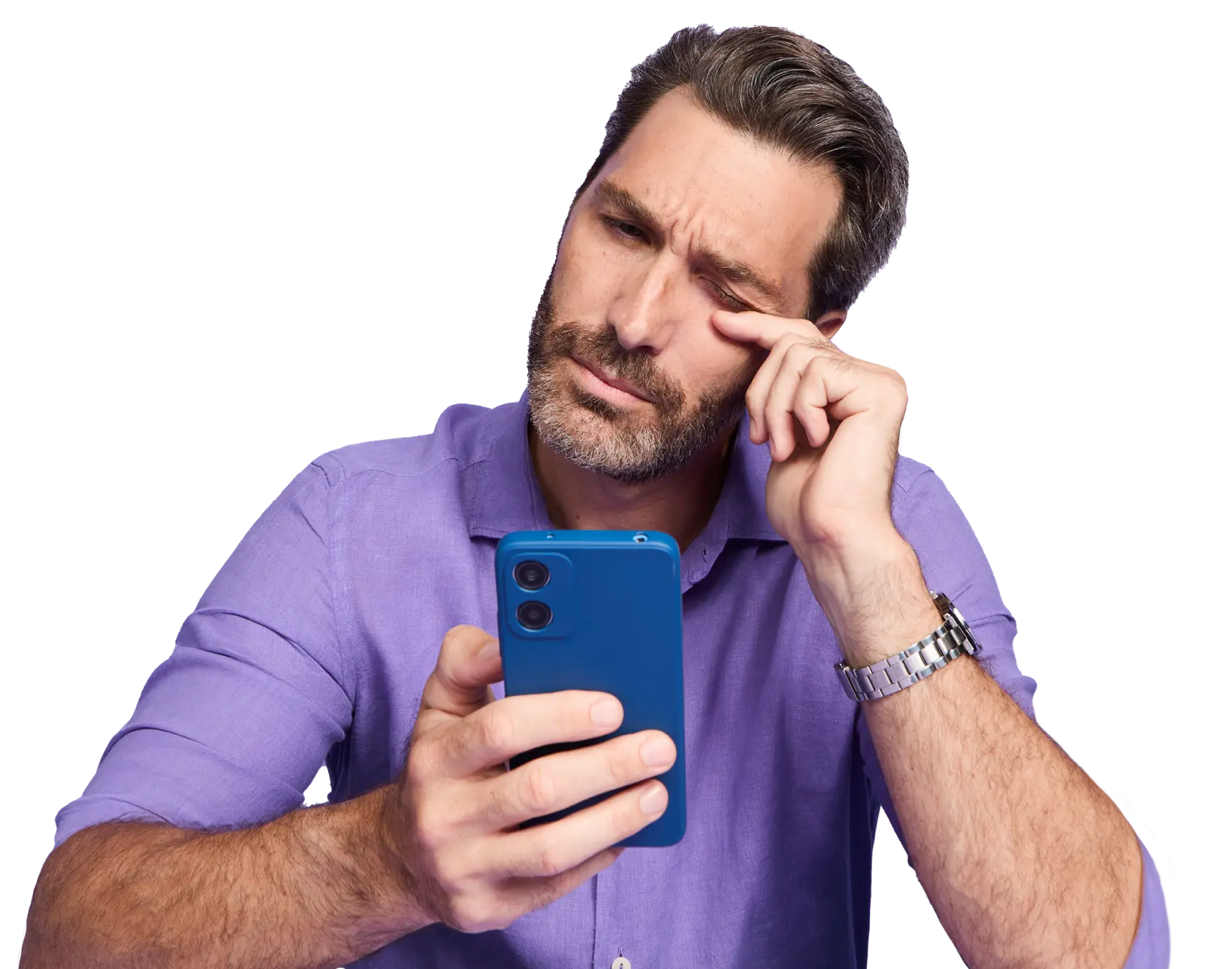 Man in a blue squinting while looking at his phone and rubbing his eye with his index finger